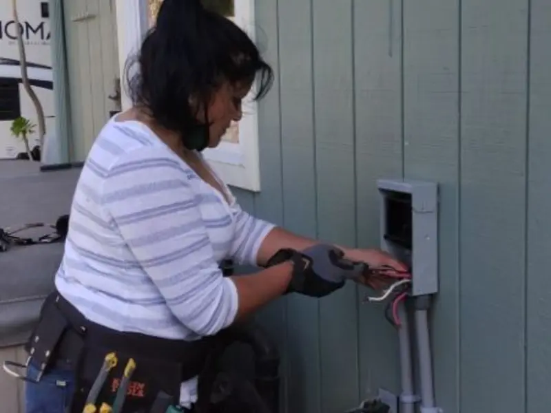 Licensed electrician wiring an exterior subpanel in Minster